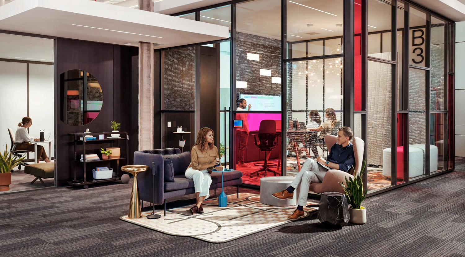 office with demountable walls and a collaborative setting just outside with people working