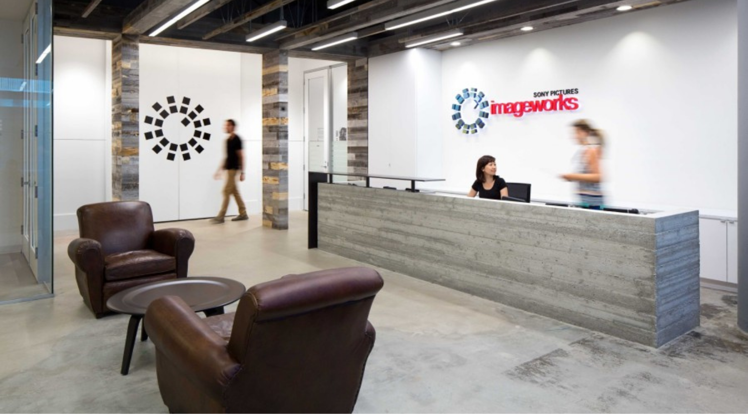 reception desk with brown leather chairs in lobby area