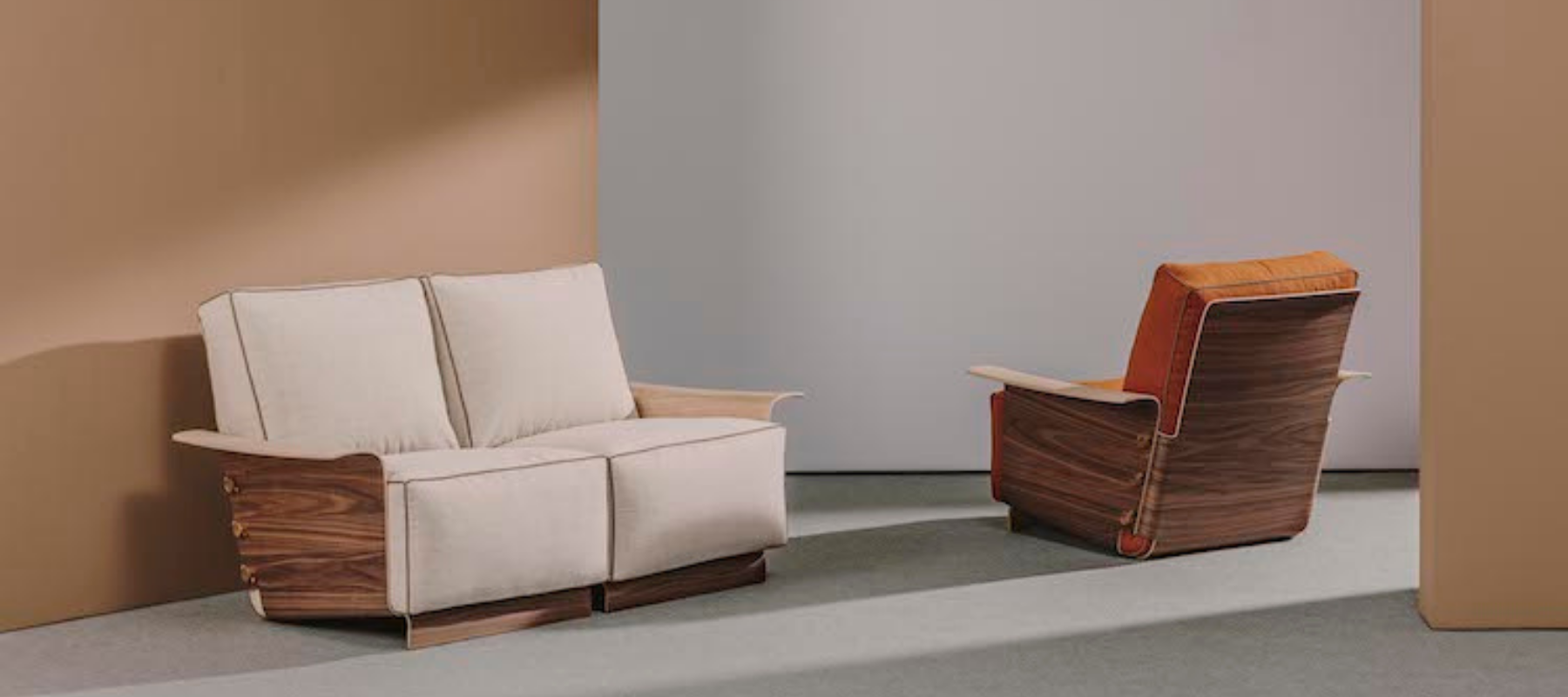 a sofa and lounge chair with wood details