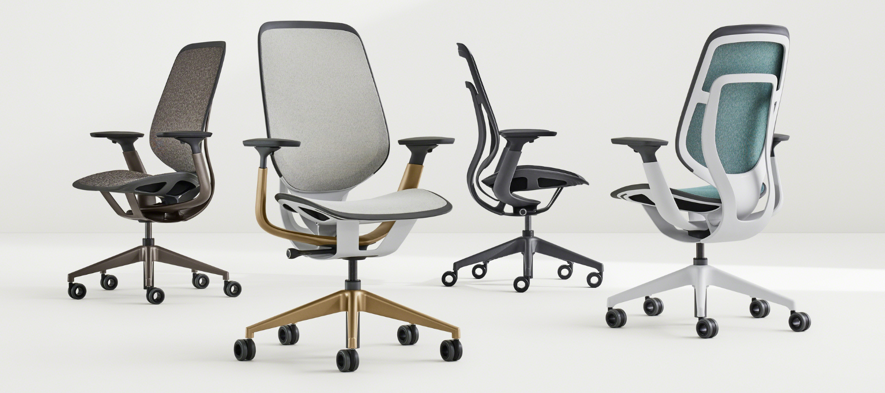 Variety of mesh task chairs on a grey background, with different finishes
