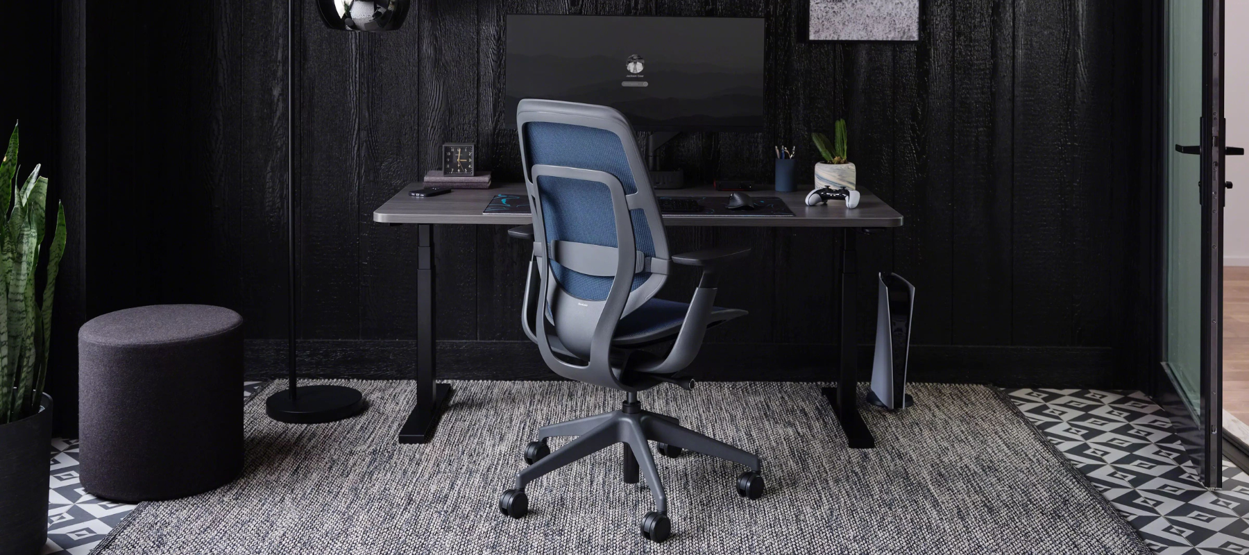 Steelcase Karman chair in blue mesh and grey frame in front of standing desk and computer